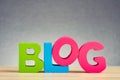 Word BLOG on wooden desk over beautiful reverberation gradient background