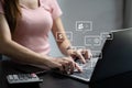 Social media and Marketing virtual icons screen of business women typing keyboard with laptop computer and smart phone at office Royalty Free Stock Photo