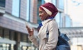 Social media, music and Muslim woman with a phone in the city for 5g connection, internet and chat. Communication Royalty Free Stock Photo