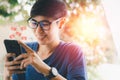 Social media with smartphone concept. Asian woma holding black mobile phone on hand with red icon of applications, internet