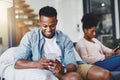 Is social media taking over their marriage. a young couple using their mobile phones on the sofa at home. Royalty Free Stock Photo
