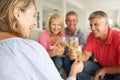 Social mid age couples drinking together at home Royalty Free Stock Photo