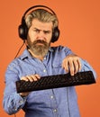 social network. downloading music from internet. bearded man headphones and keyboard. Professional Gamer Playing