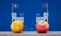 social and political polarisation, tribalism, division concept, apple and orange ideology at castles fighting Royalty Free Stock Photo