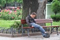 Odessa, Ukraine. A homeless sleep in a public park bench.