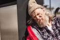 Depressed poor man leaning on to the litter bin