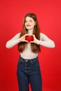 Social responsibility, a young woman blood donor holds a red heart in her hands