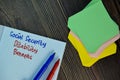 Social Security Disability Benefits write on sticky note isolated on Wooden Table. Business concept