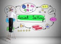 Social selling concept drawn by a man on a ladder Royalty Free Stock Photo