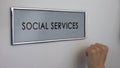 Social services office door, hand knocking, senior people support, volunteering