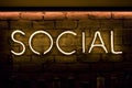 Social sign in neon yellow lights