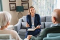 Social worker talking to senior couple at home