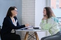 Social worker talking to teenage girl. Psychological assistance in adolescence