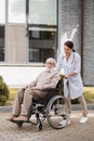 Social worker walking with elderly handicapped