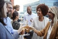 Socialising office colleagues raising glasses and making a toast with drinks after work