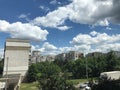 Socialistic building with green trees and beautiful clouds Royalty Free Stock Photo