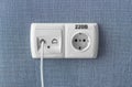 Socket on a blue wall, a multifunction outlet with an internet connection and european-style outlets Royalty Free Stock Photo