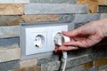 A socket with an electric plug in the wall. Energy saving concept Royalty Free Stock Photo