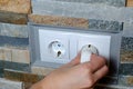 A socket with an electric plug in the wall. Energy saving concept. Royalty Free Stock Photo
