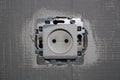 Socket on a gray-painted wall Royalty Free Stock Photo