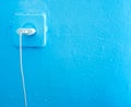 Socket with plug on a blue wall. electric plug and cord Royalty Free Stock Photo