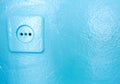 Socket with plug on a blue wall. electric plug and cord Royalty Free Stock Photo