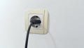 Socket plug with electric plug line on white wall Royalty Free Stock Photo