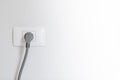 socket plug with electric plug line on white wall Royalty Free Stock Photo