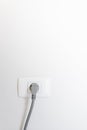 socket plug with electric plug line on white wall Royalty Free Stock Photo