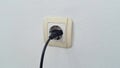 Socket plug with electric plug line on white wall Royalty Free Stock Photo