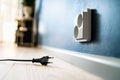 Socket and power outlet. Electric plug. Cable unplugged from wall. Wire and cord. Electricity off. Energy consumption. Royalty Free Stock Photo