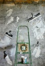 Socket, stepladder, spatulas, Bank with plaster on the background of a concrete wall. repair Royalty Free Stock Photo