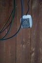 Socket with wires on a wooden background