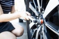 Socket wrench tool in hands of woman,closing screws the bolts,tighten the nuts or unscrews the wheel nuts,change wheel,checking Royalty Free Stock Photo