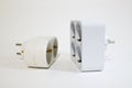 Sockets-splitters for two and four white plugs Royalty Free Stock Photo