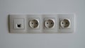 Sockets on white wall and wi-fi cable closeup Royalty Free Stock Photo