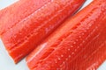 Sockeye salmon fillets on a white background.