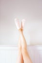 Socks on Beautiful People is Feet. Cropped Portrait of Beautiful Young Woman Wearing Bright Sock Raised Crossed Legs Isolated on Royalty Free Stock Photo