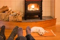 Socks and feet of a couple relaxing by fire with west highland t