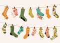 Socks on rope. Cartoon dry socks on textile cord, knitted wool fabric for winter wear, comfortable foot wear accessory