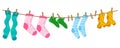 Socks on rope with clothespins isolated on white background. Different color socks set hang on laundry string.