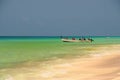 Socotra, Yemen, March 9, 2015 Simple rural fishermen returning from fishing to drag the boat out of the water on the shores of an Royalty Free Stock Photo