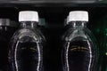 Soda Bottles in Vending Machine White Bottle Caps Black Liquid R Royalty Free Stock Photo