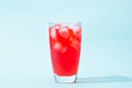 Soda. Red sparkling water with ice in a glass Royalty Free Stock Photo