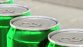 Soda, soft drink or beer production line. Green aluminum cans on industrial conveyor. Recycling ecologic packaging. 3D Royalty Free Stock Photo