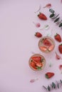 Soda with strawberries on a pink background. Summer refreshing d