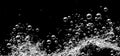 Soda water bubbles splashing underwater against black background Royalty Free Stock Photo