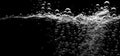 Soda water bubbles splashing underwater against black background Royalty Free Stock Photo