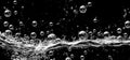 Soda water bubbles splashing underwater against black background Royalty Free Stock Photo