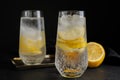 Soda water with lemon slices and ice cubes on black table Royalty Free Stock Photo